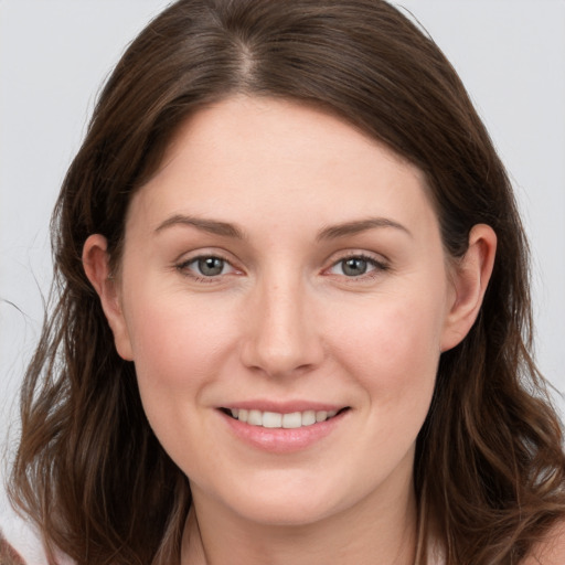 Joyful white young-adult female with long  brown hair and grey eyes