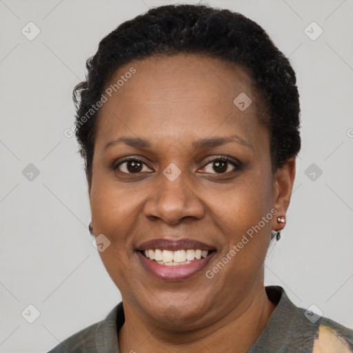 Joyful black adult female with short  brown hair and brown eyes