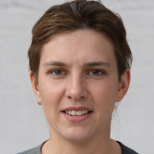 Joyful white young-adult female with short  brown hair and grey eyes