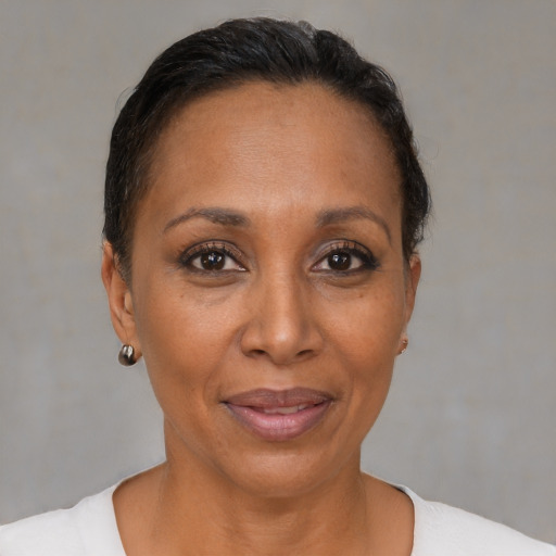 Joyful black adult female with short  brown hair and brown eyes