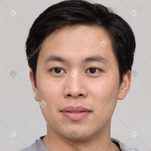 Joyful asian young-adult male with short  brown hair and brown eyes