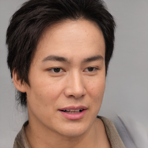 Joyful asian young-adult female with short  brown hair and brown eyes
