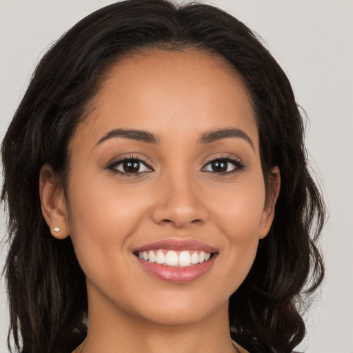 Joyful white young-adult female with long  brown hair and brown eyes