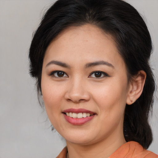 Joyful asian young-adult female with medium  brown hair and brown eyes