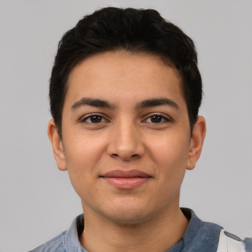 Joyful latino young-adult male with short  black hair and brown eyes