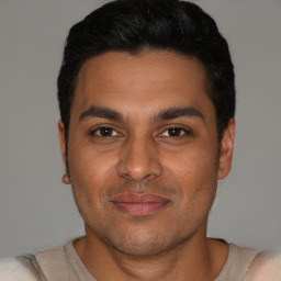 Joyful white young-adult male with short  black hair and brown eyes