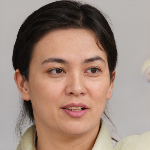 Joyful white adult female with medium  brown hair and brown eyes
