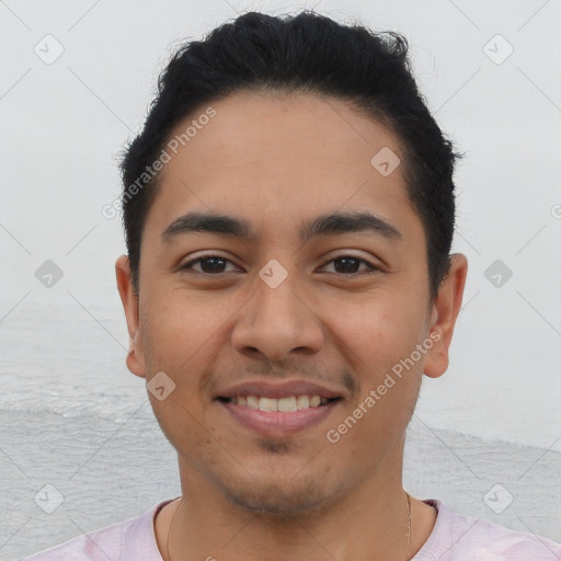 Joyful latino young-adult male with short  black hair and brown eyes