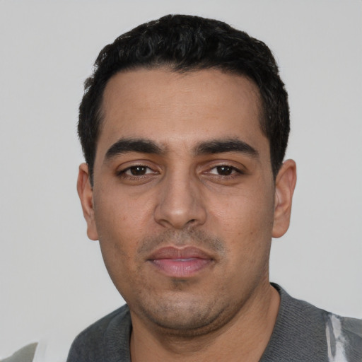 Neutral latino young-adult male with short  black hair and brown eyes