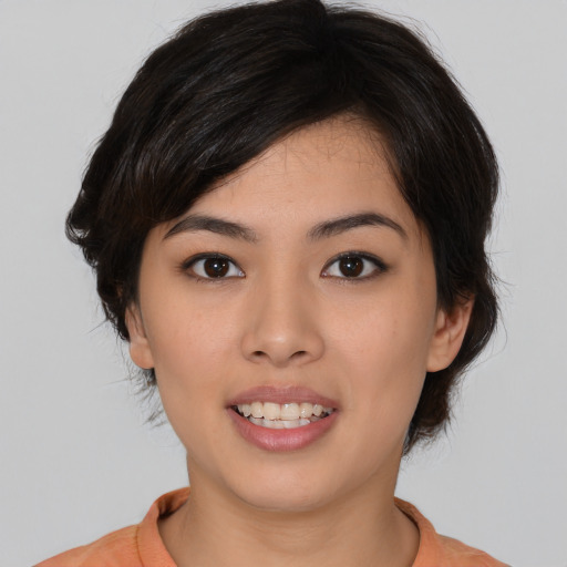 Joyful asian young-adult female with medium  black hair and brown eyes