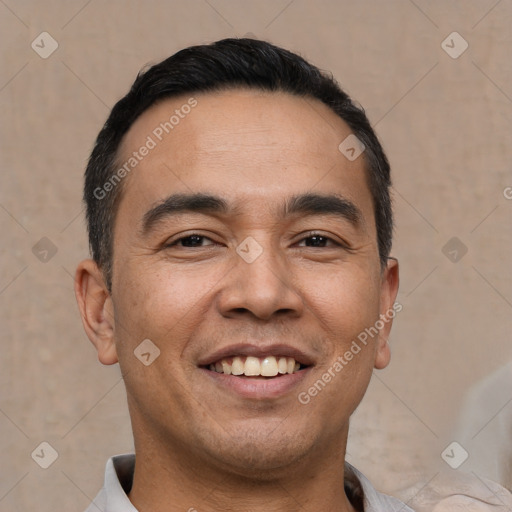 Joyful white adult male with short  black hair and brown eyes