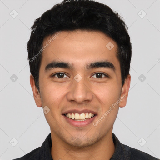 Joyful latino young-adult male with short  black hair and brown eyes