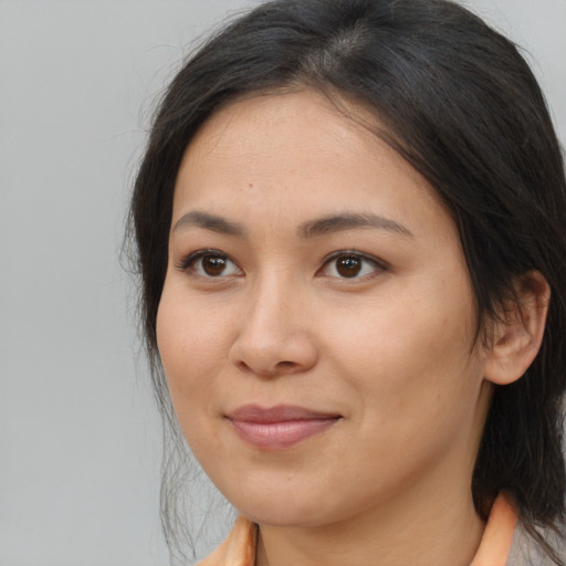 Joyful asian young-adult female with medium  brown hair and brown eyes
