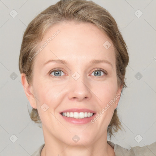 Joyful white adult female with medium  brown hair and blue eyes