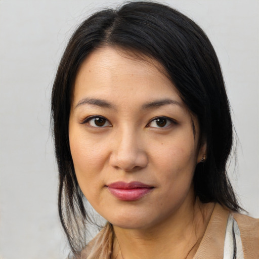 Joyful asian young-adult female with medium  black hair and brown eyes