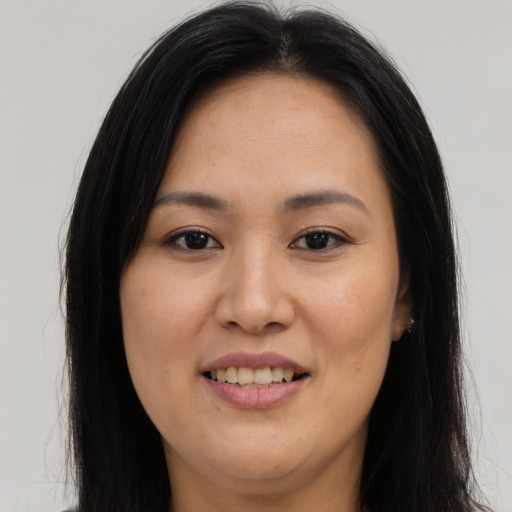 Joyful asian young-adult female with long  brown hair and brown eyes