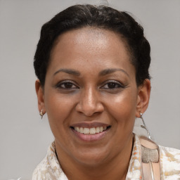 Joyful black adult female with short  brown hair and brown eyes