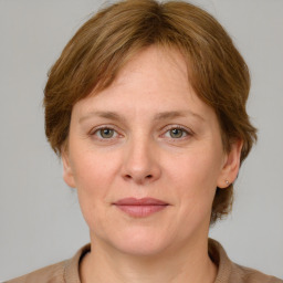 Joyful white adult female with medium  brown hair and grey eyes