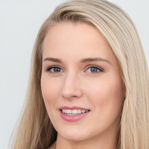 Joyful white young-adult female with long  brown hair and blue eyes