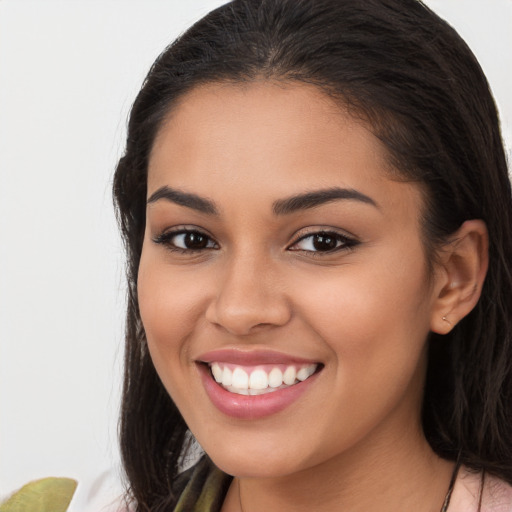 Joyful latino young-adult female with long  brown hair and brown eyes