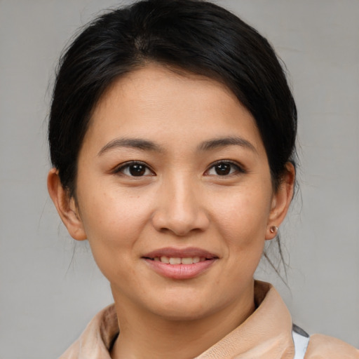 Joyful asian young-adult female with medium  brown hair and brown eyes