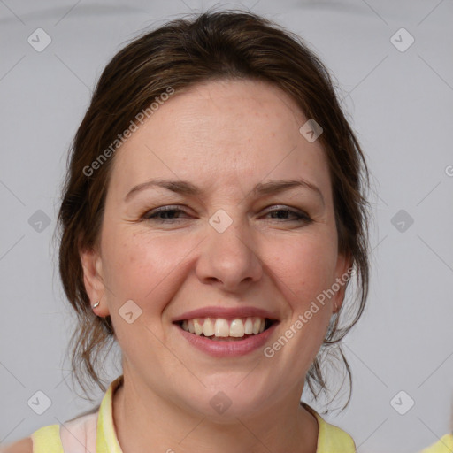 Joyful white adult female with medium  brown hair and blue eyes