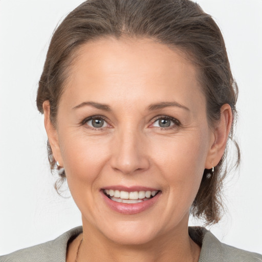 Joyful white adult female with medium  brown hair and brown eyes