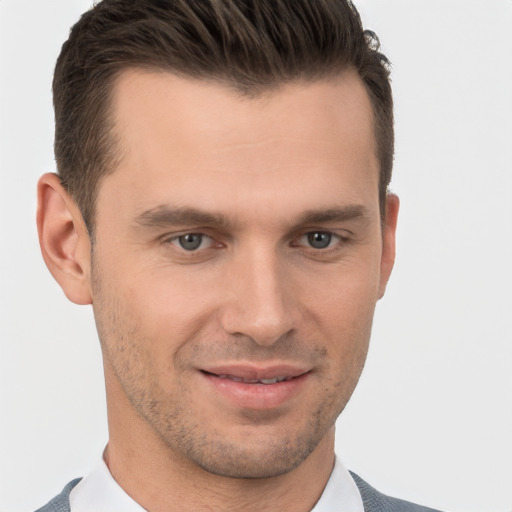 Joyful white young-adult male with short  brown hair and brown eyes