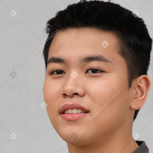 Joyful asian young-adult male with short  black hair and brown eyes