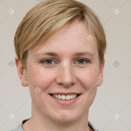 Joyful white young-adult female with short  brown hair and grey eyes