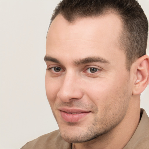 Joyful white young-adult male with short  brown hair and brown eyes