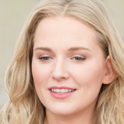 Joyful white young-adult female with long  brown hair and blue eyes