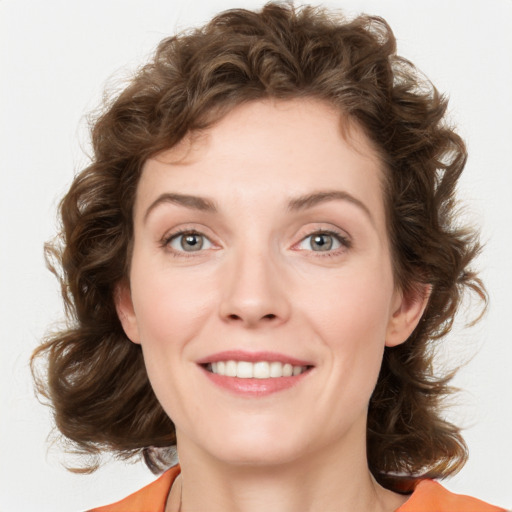 Joyful white young-adult female with medium  brown hair and green eyes