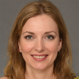 Joyful white young-adult female with long  brown hair and green eyes