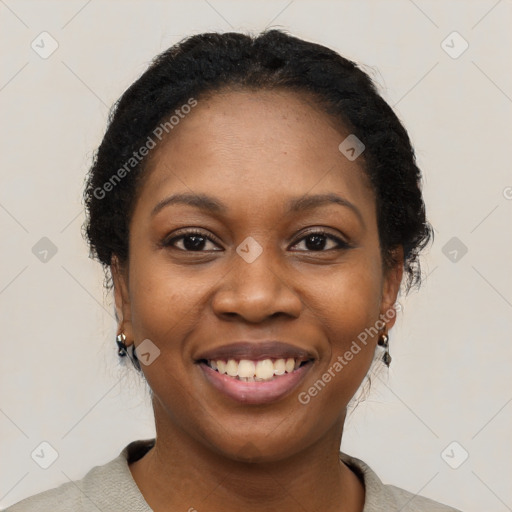 Joyful black young-adult female with short  black hair and brown eyes