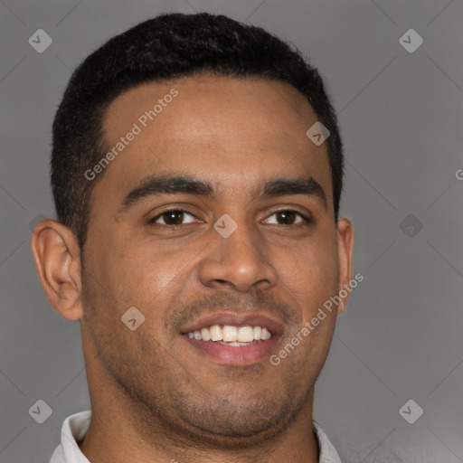 Joyful black young-adult male with short  brown hair and brown eyes