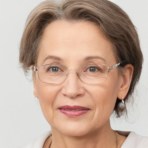 Joyful white middle-aged female with medium  brown hair and brown eyes