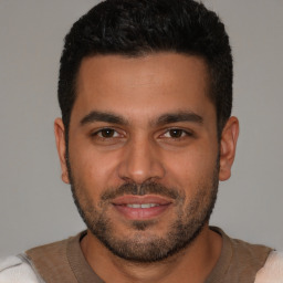 Joyful latino young-adult male with short  brown hair and brown eyes