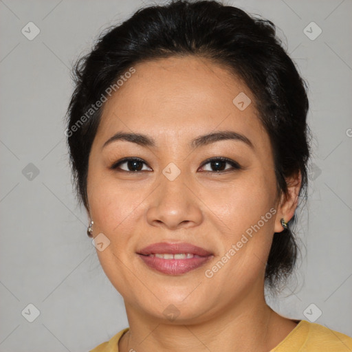 Joyful latino adult female with medium  brown hair and brown eyes