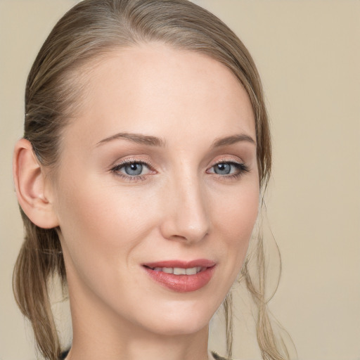 Joyful white young-adult female with long  brown hair and blue eyes