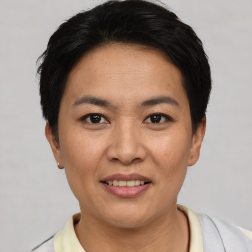 Joyful asian young-adult female with short  black hair and brown eyes
