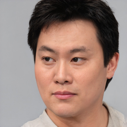Neutral asian young-adult male with short  brown hair and brown eyes