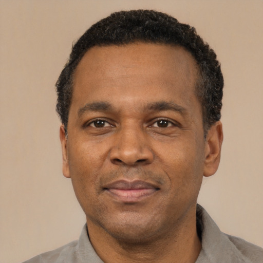 Neutral latino adult male with short  black hair and brown eyes