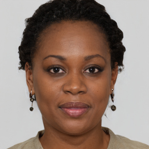 Joyful black adult female with short  brown hair and brown eyes