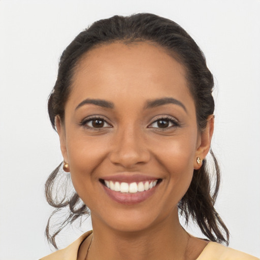 Joyful latino young-adult female with long  brown hair and brown eyes