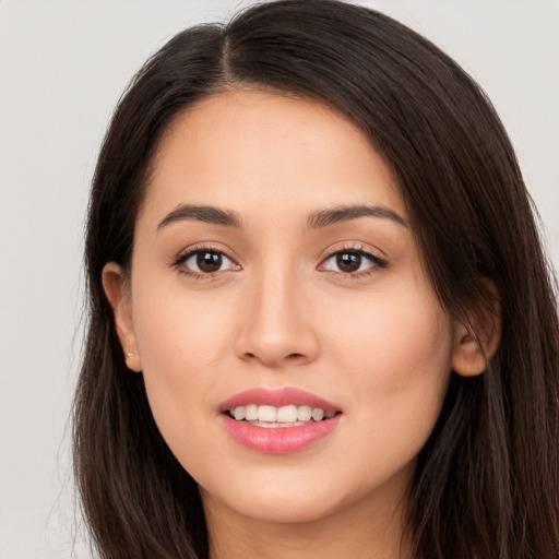 Joyful white young-adult female with long  brown hair and brown eyes