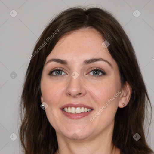 Joyful white adult female with long  brown hair and brown eyes