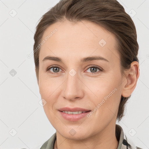 Joyful white young-adult female with medium  brown hair and grey eyes