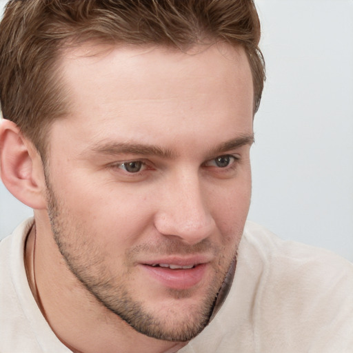 Joyful white young-adult male with short  brown hair and blue eyes