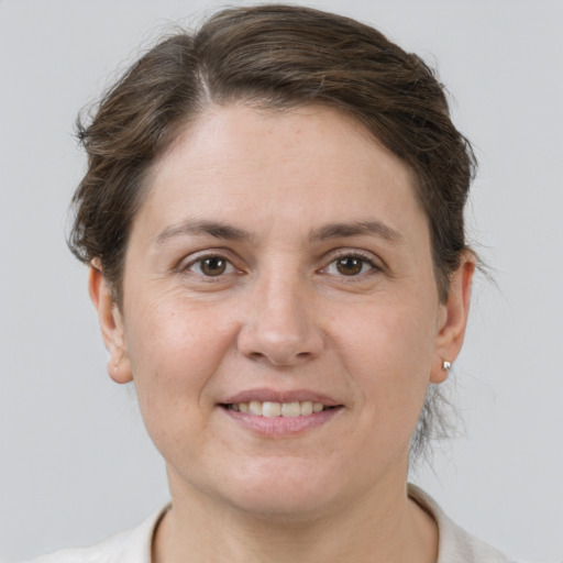 Joyful white young-adult female with short  brown hair and grey eyes